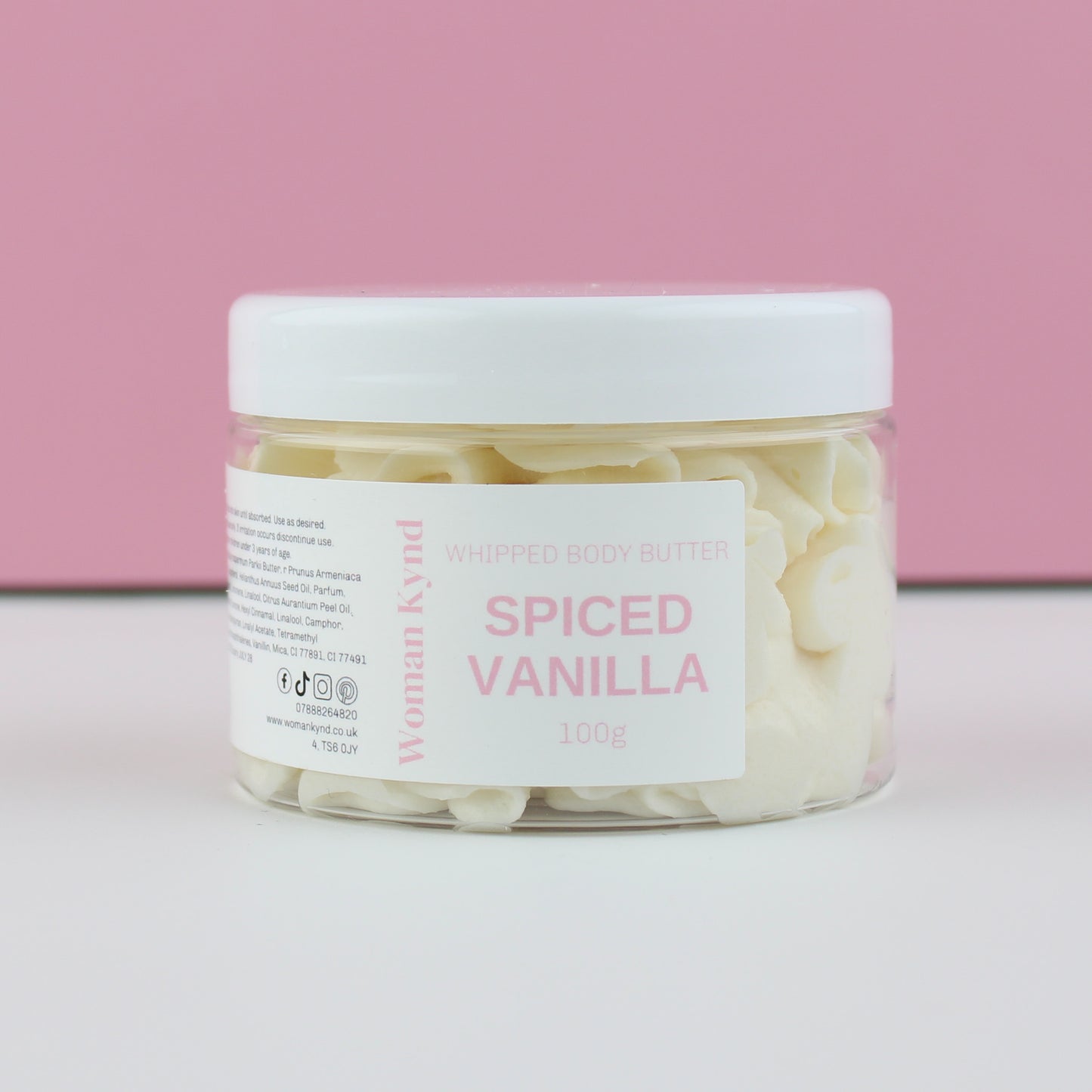 Jar of spiced vanilla whipped body butter with a pink background