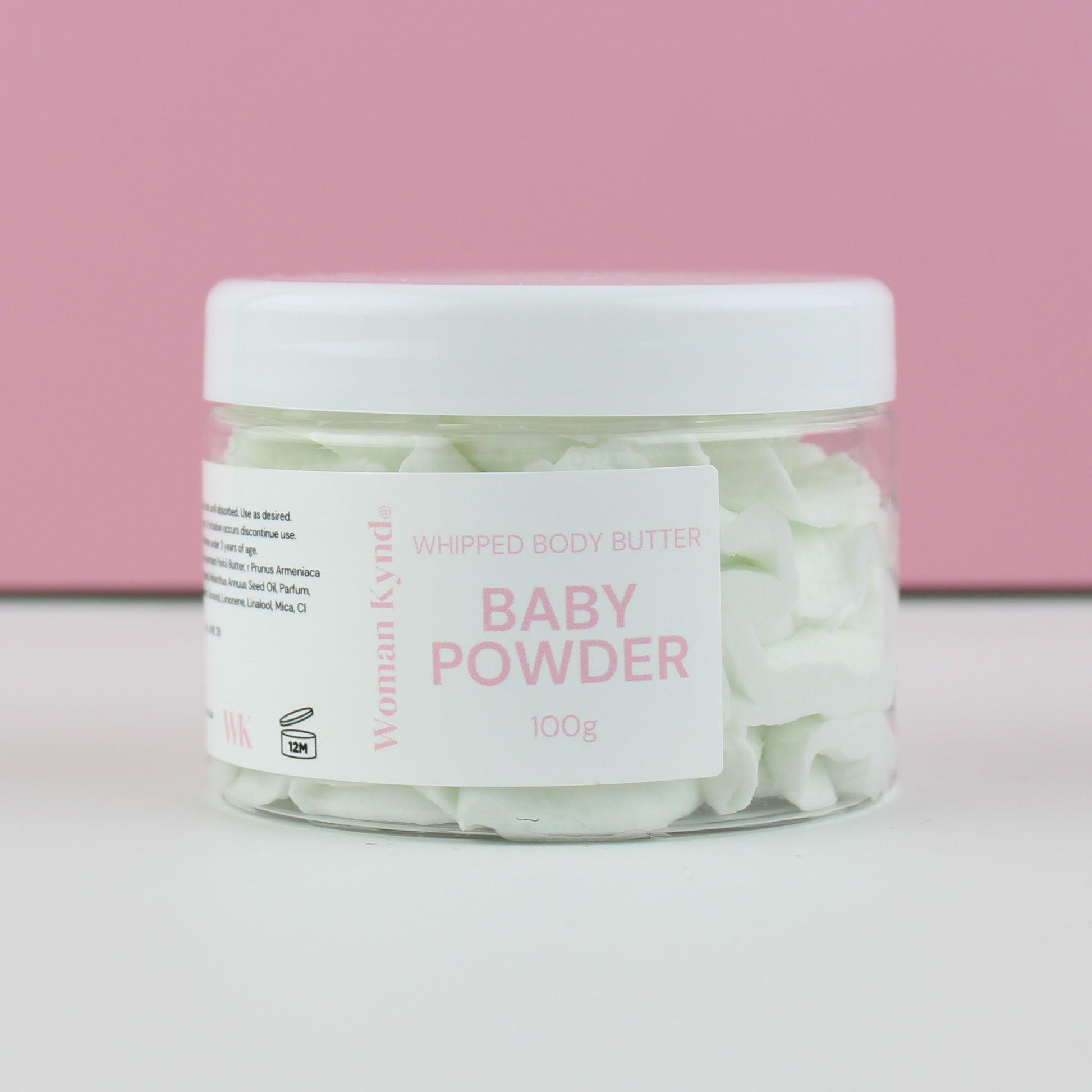 Jar of baby powder with a white lid on a pink background