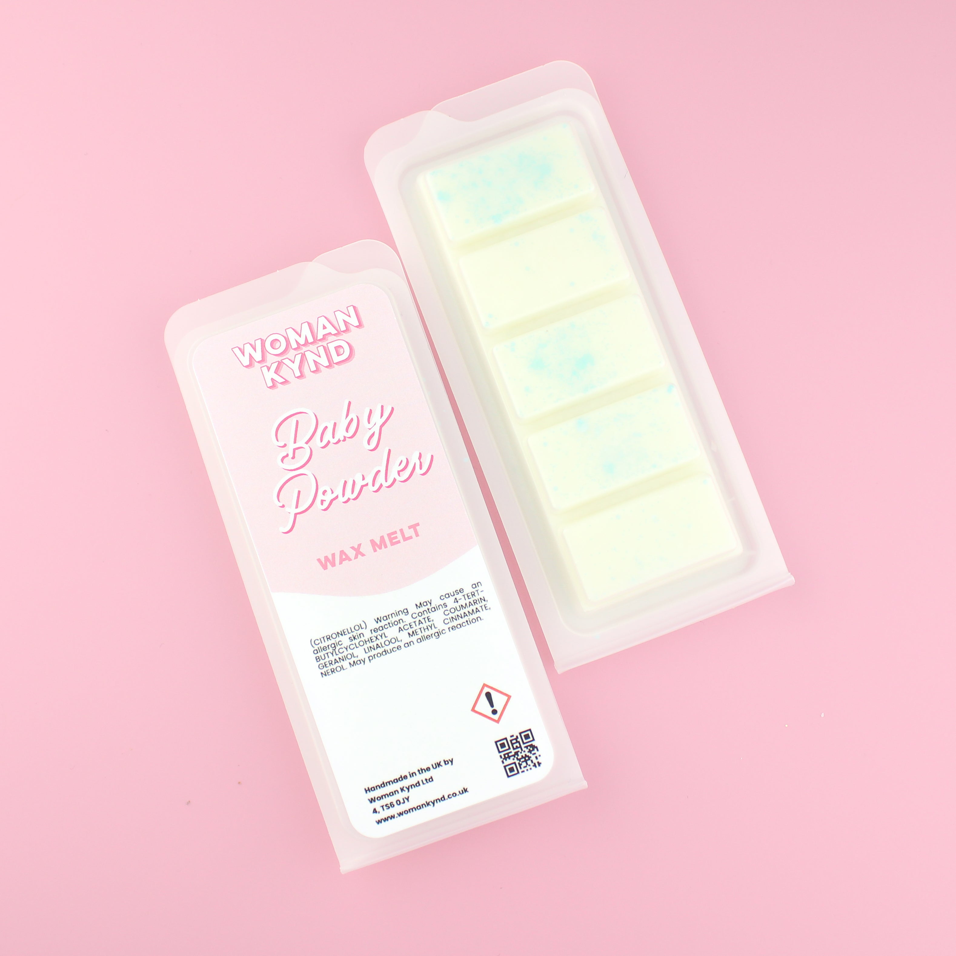 Woman Kynd Wax Melt shown in frosted clamshell packaging with blue glitter on a pink background.