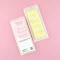 Two images of a Woman Kynd five segment beige Wax Melt with gold glitter, both in a frosted clamshell. The first image displays the pink and white label with the words Woman Kynd Blonde Moment Wax Melt and the CLP information, and the other image is of the reverse side showing the Wax Melt Itself. Both images are against a solid pink background.