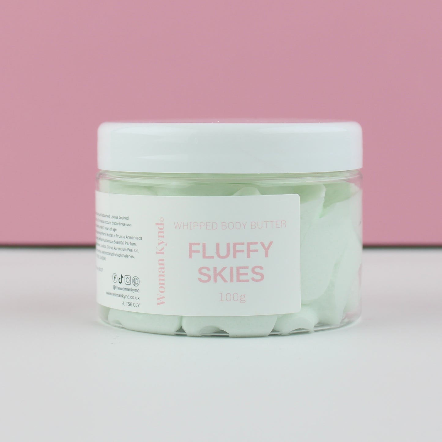 Jar of 'Fluffy Skies' whipped body butter with a pink background