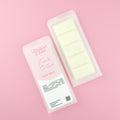 Two images of a Woman Kynd five segment white Wax Melt with white glitter, both in a frosted clamshell. The first image displays the pink and white label with the words Woman Kynd Fresh Cotton Wax Melt and the CLP information, and the other image is of the reverse side showing the Wax Melt Itself. Both images are against a solid pink background.