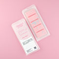 Two images of a Woman Kynd five segment pink Wax Melt with blue and silver shaped glitter, both in a frosted clamshell. The first image displays the pink and white label with the words Woman Kynd Hotel Of Dreams Wax Melt and the CLP information, and the other image is of the reverse side showing the Wax Melt Itself. Both images are against a solid pink background.