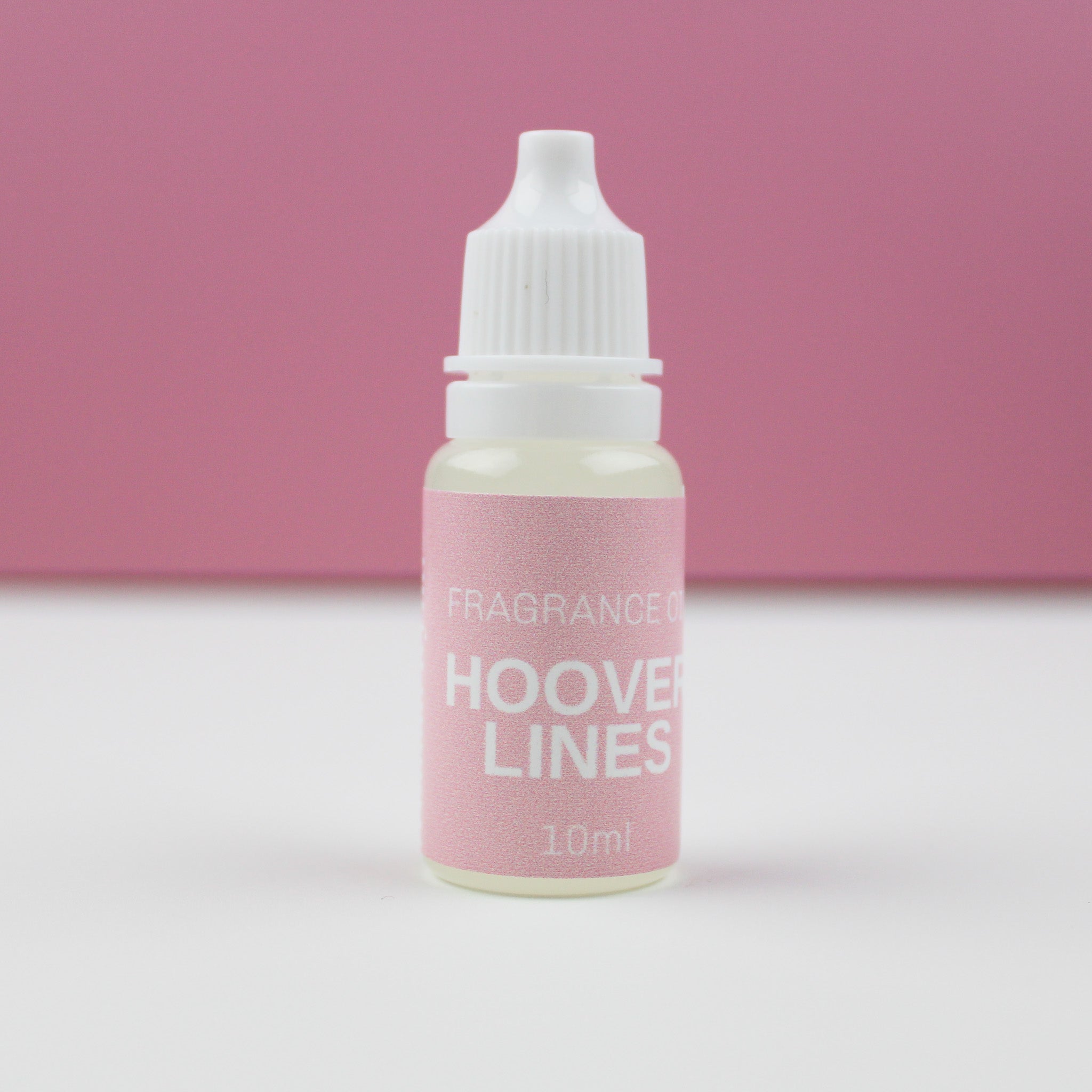 A small white bottle with a pink label that reads 'FRAGRANCE HOOVER LINES' on a pink background.