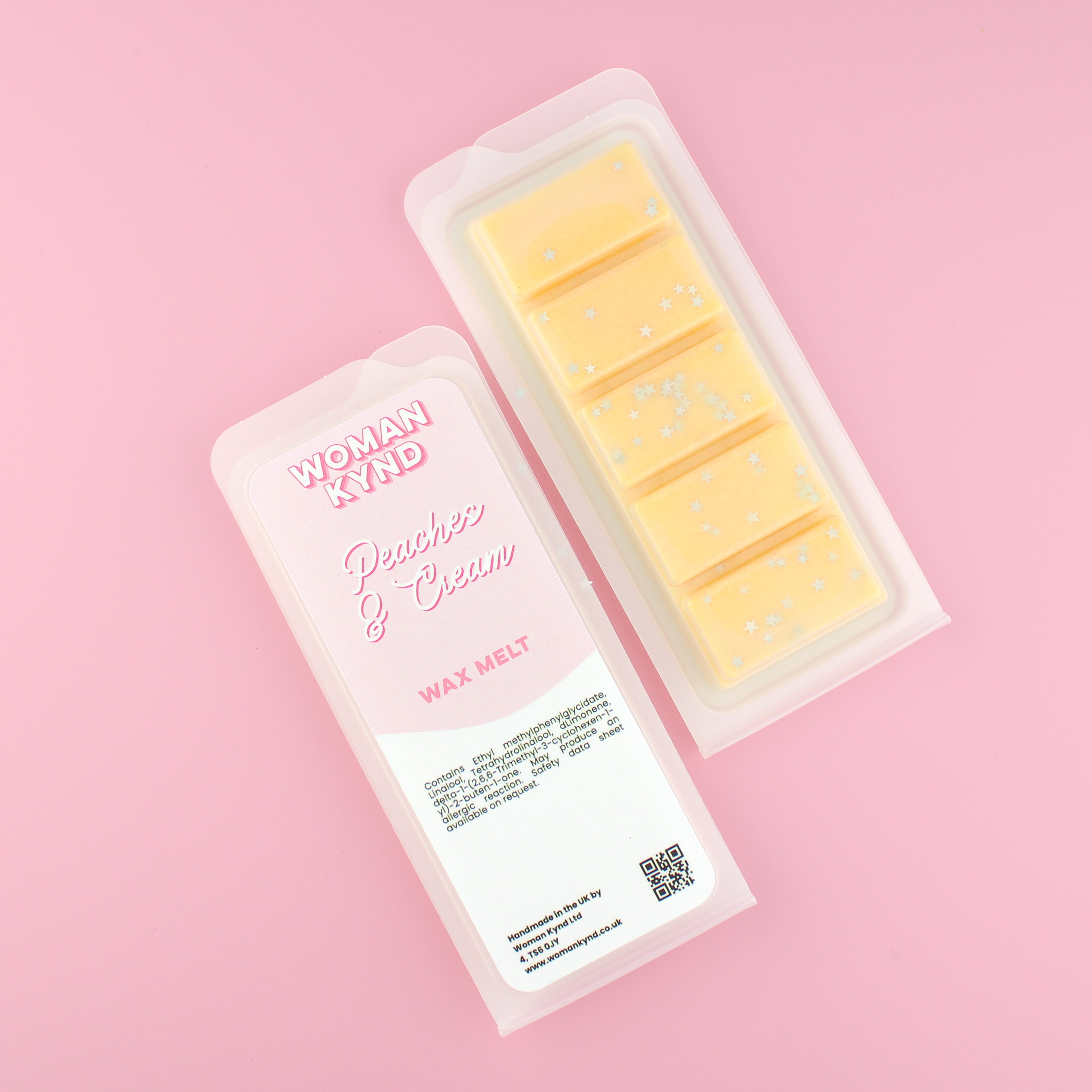 Two images of a Woman Kynd five segment yellow Wax Melt with silver glitter, both in a frosted clamshell. The first image displays the pink and white label with the words Woman Kynd Peaches & Cream Wax Melt and the CLP information, and the other image is of the reverse side showing the Wax Melt Itself. Both images are against a solid pink background.