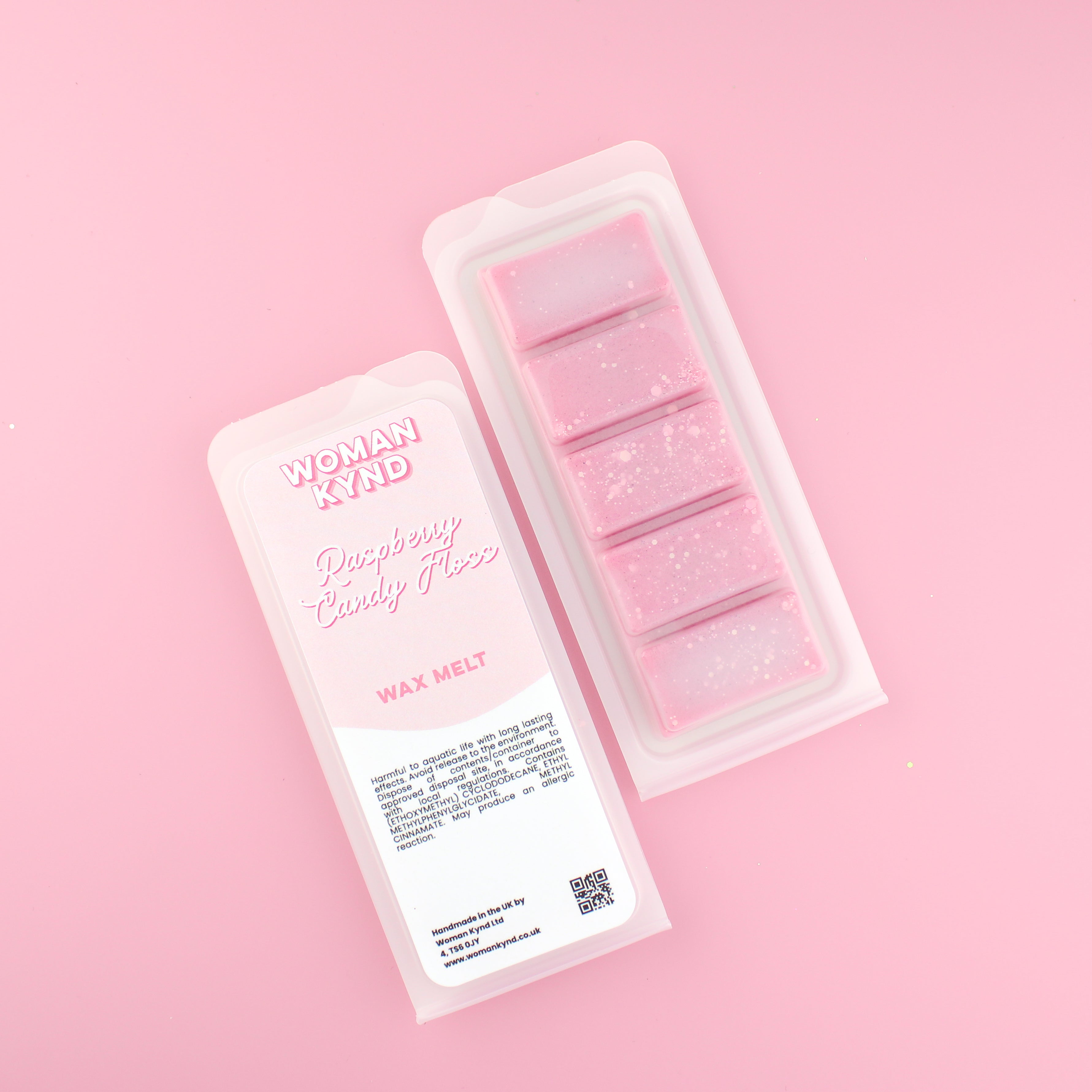 Two images of a Woman Kynd five segment pink Wax Melt with light pink glitter, both in a frosted clamshell. The first image displays the pink and white label with the words Woman Kynd Raspberry Candy Floss Wax Melt and the CLP information, and the other image is of the reverse side showing the Wax Melt Itself. Both images are against a solid pink background.