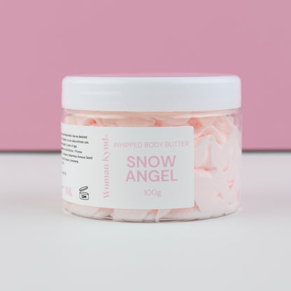 Jar of 'Snow Angel' whipped body butter with a pink and white label on a light pink background