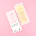 Two images of a Woman Kynd five segment cream coloured Wax Melt with bronze glitter, both in a frosted clamshell. The first image displays the pink and white label with the words Woman Kynd Spiced Vanilla Wax Melt and the CLP information, and the other image is of the reverse side showing the Wax Melt Itself. Both images are against a solid pink background.
