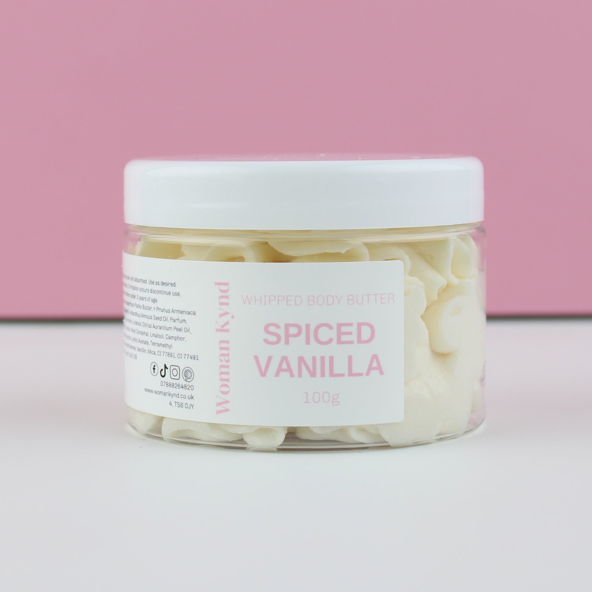 Jar of spiced vanilla whipped body butter with a pink background