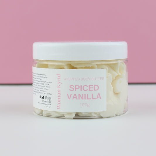 Jar of spiced vanilla whipped body butter with a pink background