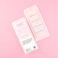 Two images of a Woman Kynd five segment pale pink Wax Melt with pale blue glitter, both in a frosted clamshell. The first image displays the pink and white label with the words Woman Kynd Tidal Cherry Blossom Wax Melt and the CLP information, and the other image is of the reverse side showing the Wax Melt Itself. Both images are against a solid pink background.